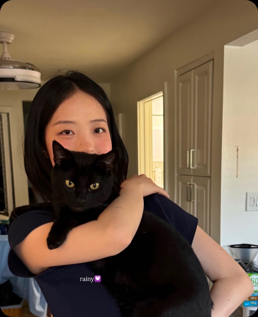 Haven holding her black cat Rainy with text rainy 💜